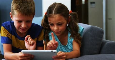 siblings using digital tablet in living room stock footage videohive