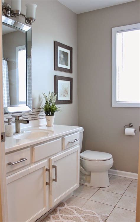 If you like the idea of open shelving but don't want your stuff just hanging out, try a cabinet with glass doors. Guest Bathroom Reveal | Beige tile bathroom, Bathroom ...