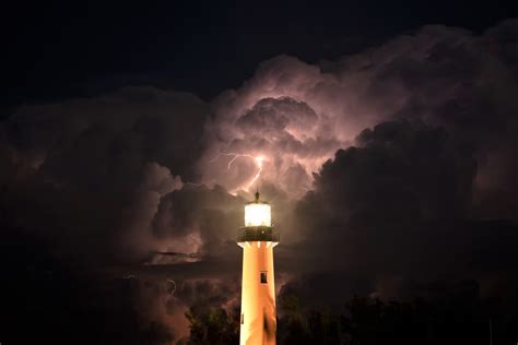 Lighthouse In A Thunderstorm 4k Ultra Hd Wallpaper Background Image