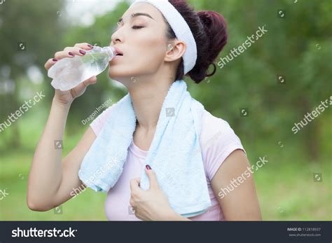 Thirsty Woman Drinking Cold Water After Working Out Stock Photo
