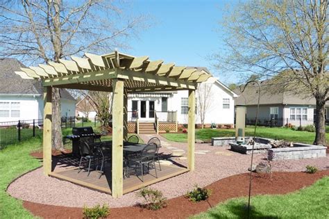The fire casts a gorgeous glow in the center of a table that leaves enough room around the edges for drinks and snacks. Pergola with composite deck and Fire Pit seating area. in ...