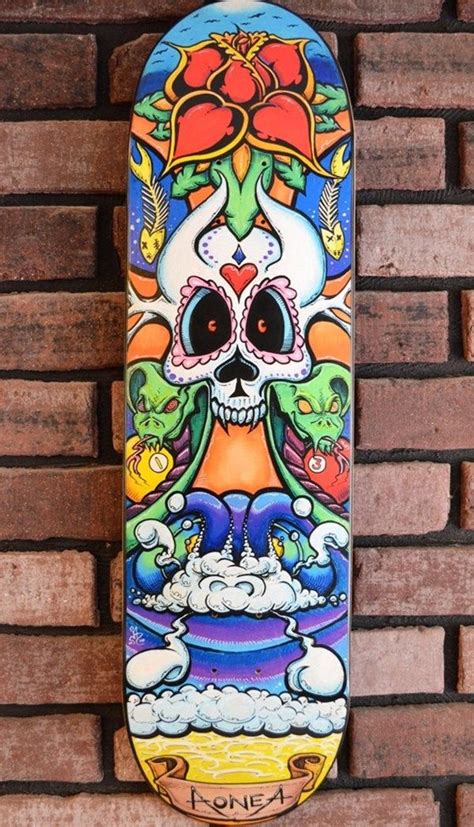 A Colorful Skateboard Hanging On A Brick Wall With An Image Of A Skull