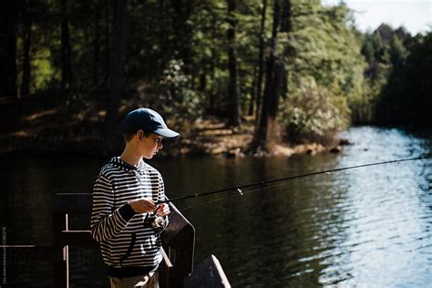Teen Boy Fishing On Lake By Stocksy Contributor Lea Jones Stocksy