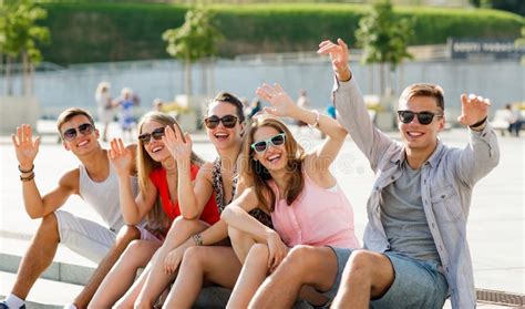 Group Of Laughing Friends Sitting On City Square Friendship Leisure Summer G Ad Sitting