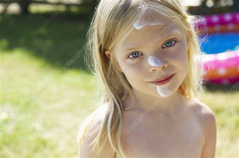 girl with sunscreen cream on her face stock image f003 6702 science photo library