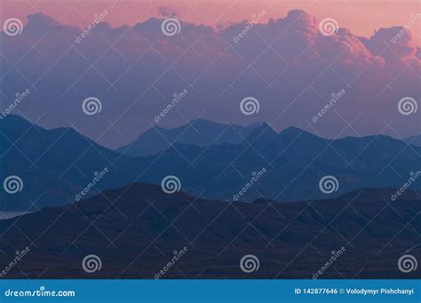 Purple Sunset In The Mountains Evening Landscape In A Hilly Area With