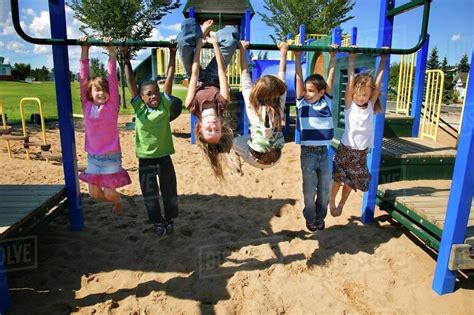 Group Of Children Playing In A Park Stock Photo Dissolve