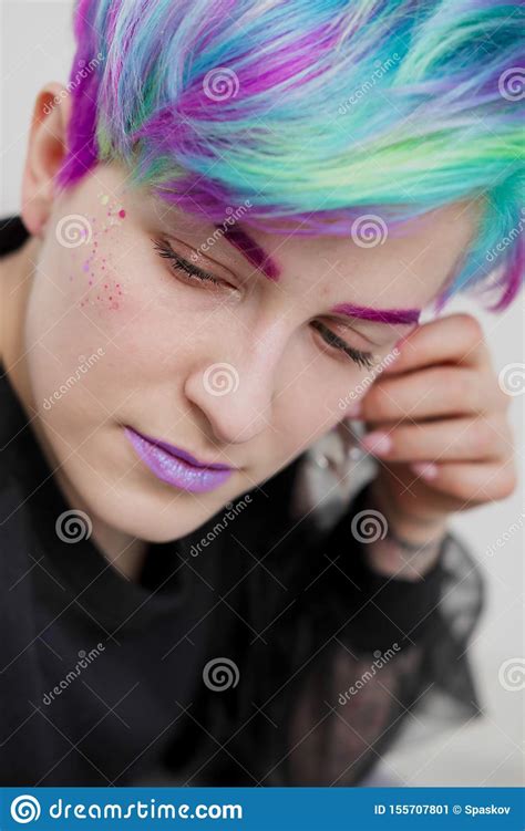 Young Beautiful Woman With Dyed Blue And Green Hair Pixie