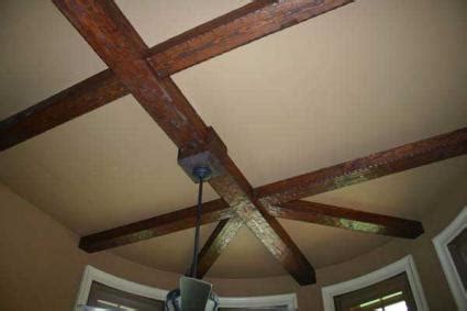 Since the base is attached to the ceiling and the blades are only a few inches below it, it's also called a ceiling hugger fan (your fun fact for the day!). Decorative Ceiling Beams | LoveToKnow