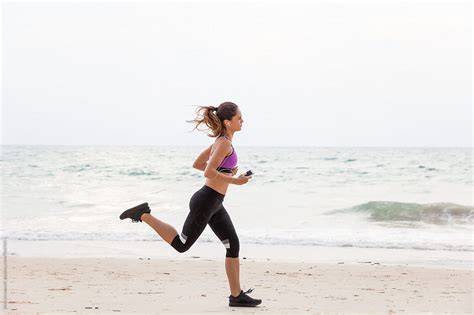 Woman Running On The Beach Fitness Outdoors Del Colaborador De Stocksy Jovo Jovanovic