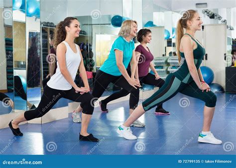 Positive Females Working Out At Aerobic Class In Modern Gym Stock Image
