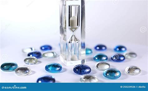 Modern Glass Hourglasses Rotate Against A White Background Stock Photo