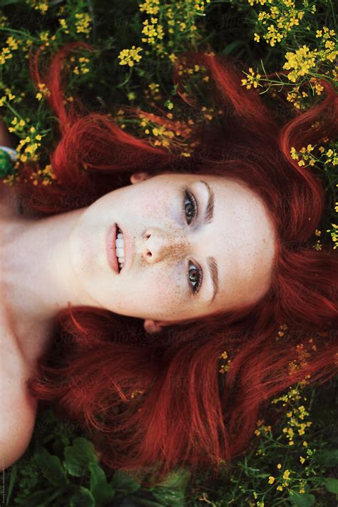 Beautiful Ginger Haired Woman Among The Flowers By Stocksy