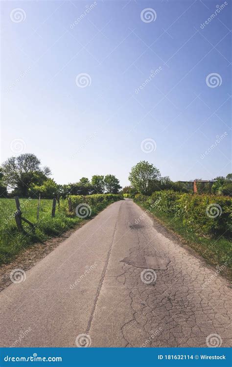 Amazing Vertical Shot Of A Beautiful Countryside Road Stock Photo