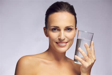 Beautiful Smiling Woman Holding A Glass Of Pure Water Stock Photo