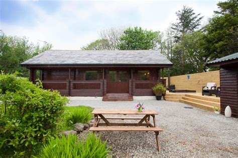 Rustic wooden cabin with a cedar barrel hot tub. Gisburn Forest Lodge, Tosside - Log Cabin with Hot Tub