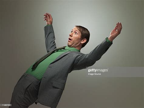 Mid Adult Businessman Falling Backwards Portrait High-Res Stock Photo ...