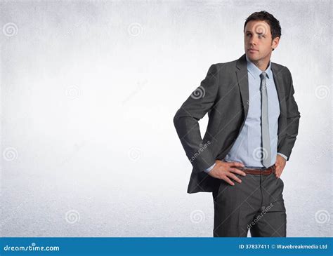 Composite Image Of Serious Businessman With Hands On Hips Stock Image