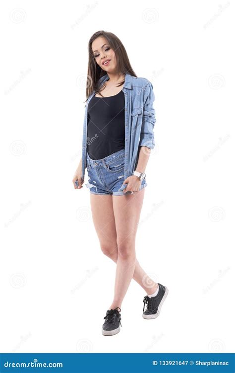 brunette stunning beauty woman in denim jeans shirt and shorts posing and looking at camera