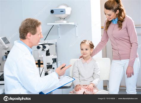 Mother Daughter Listening Ophthalmologist Consulting Room Stock Photo