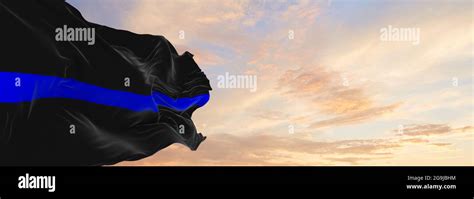 Thin Blue Line Flag Waving At Cloudy Sky Background On Sunset
