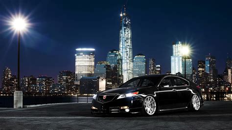 Black Car Acura Tl On A Background Of Night Skyscrapers