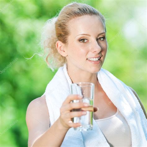 Woman Drinking Water After Exercise — Stock Photo © Markin 8461952