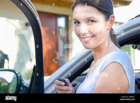 Brunette Attractive Woman Shows Her New Keys For Her Car Stock Photo
