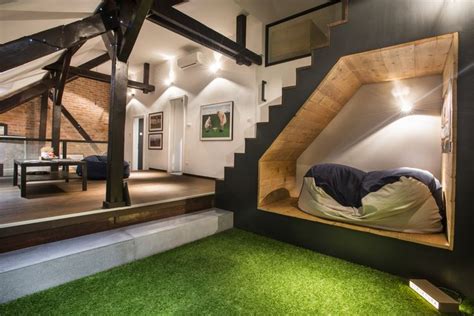 A Bed In The Corner Of A Room With Grass On The Floor And Stairs
