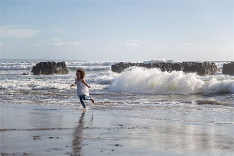 Cute Little Girl Running At The Beach Alone By Stocksy Contributor