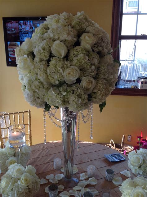 Wedding Centerpiece Of White Roses And White Hydrangea With Handing