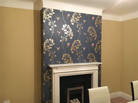 A Living Room With A Fireplace And Wall Paper