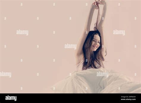 Healthy Lifestyle A Young Beautiful Brunette Woman Wakes Up In Her Bed