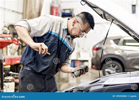 Handsome Mechanic Job In Uniform Working On Car Stock Photo Image Of