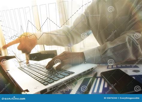 Business Man Hand Working On Laptop Computer On Wooden Desk Stock Photo