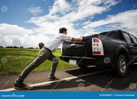 Man Pushing A Broken Car Down The Road Stock Image Image Of