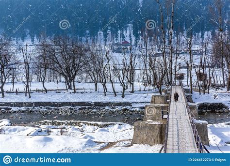 Kashmiri Villagers Crossing The River With A Bridge Built On The