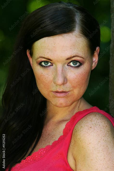 German Girl With Freckles And Long Black Hair And Blue Eyes Stock Photo