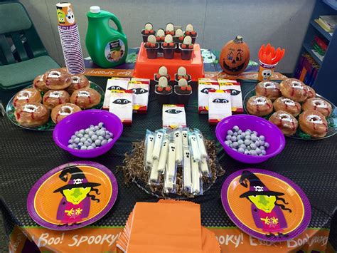 A Table Set Up With Halloween Themed Plates And Decorations
