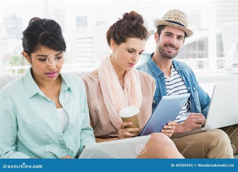 Business People Working With Laptop And Tablet On Couch Stock Image