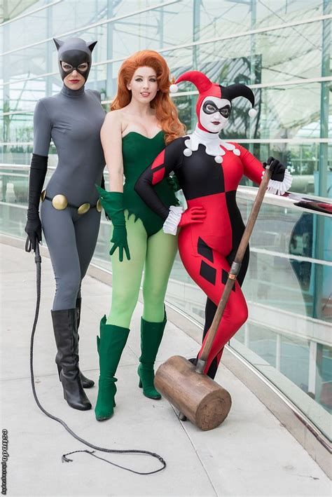 Two Women In Costumes Standing Next To Each Other