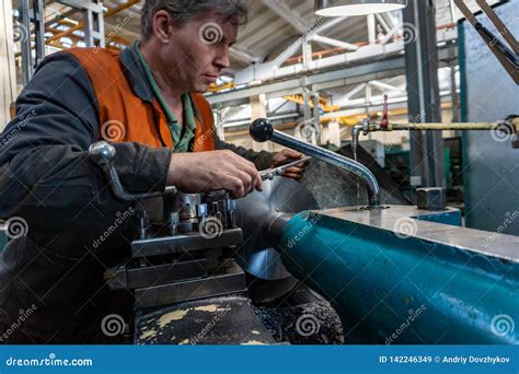 Turner Worker Manages The Metalworking Process Of Mechanical Cutting On