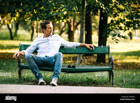 Atractive Adult Man Sitting Alone On Bench In Park Stock Photo Alamy