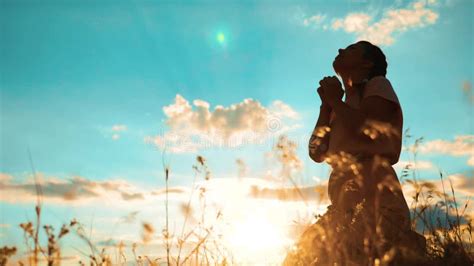 Girl Folded Her Hands In Prayer Silhouette At Sunset Woman Praying On