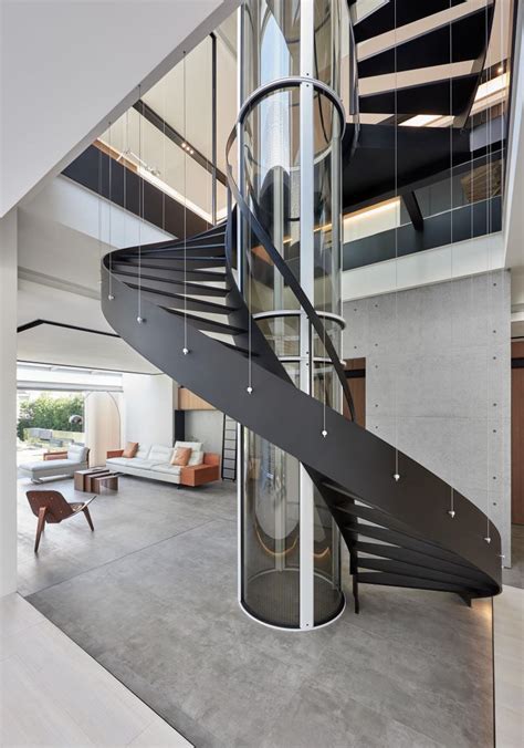 Spiral Staircase And Glass Elevator Breaking Through Transparent Floors