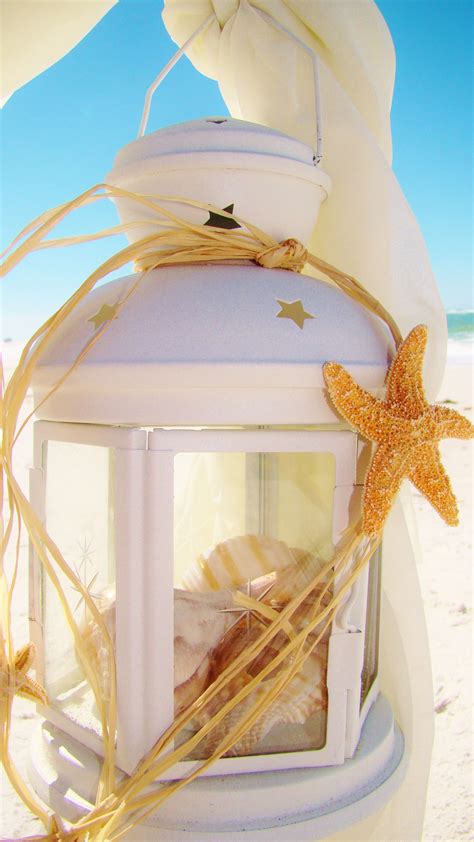 Thinking how to decorate your centerpiece? NEW Nautical seascape lantern hung on white sheppard hooks ...