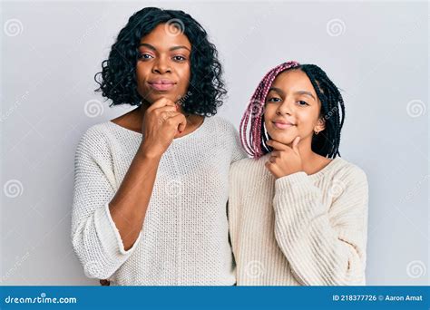 Beautiful African American Mother And Daughter Wearing Casual Clothes