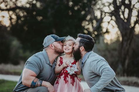 we are the adults dad and step dad pose with daughter before father daughter dance good