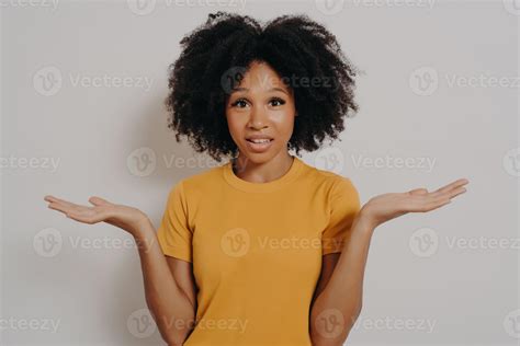 Confused Doubtful Black Woman Shrugging With Shoulders Feeling Baffled