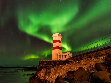 Aurora Borealis Over A Lighthouse In Iceland Wind Mills Water Tower